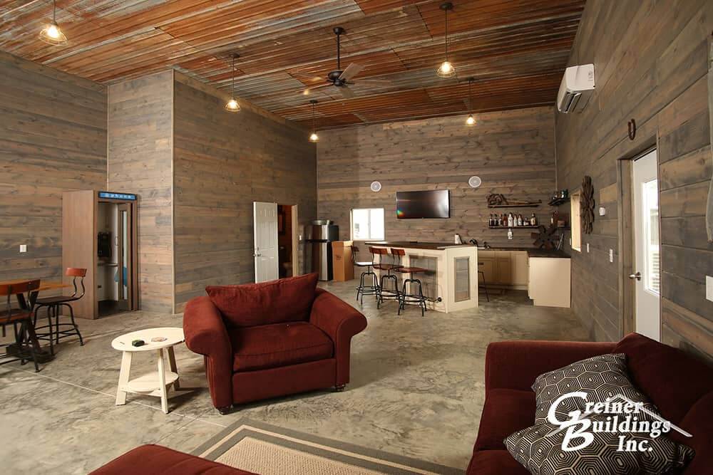 inside a finished man cave metal pole barn with wood walls and metal celing