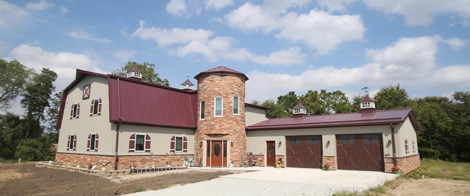 Unique pole barn house with brick and tower