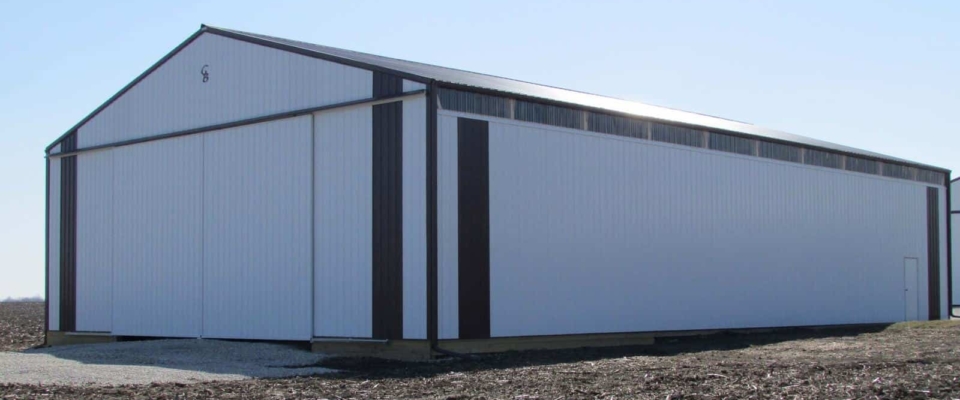 white machine shed with sliding doors
