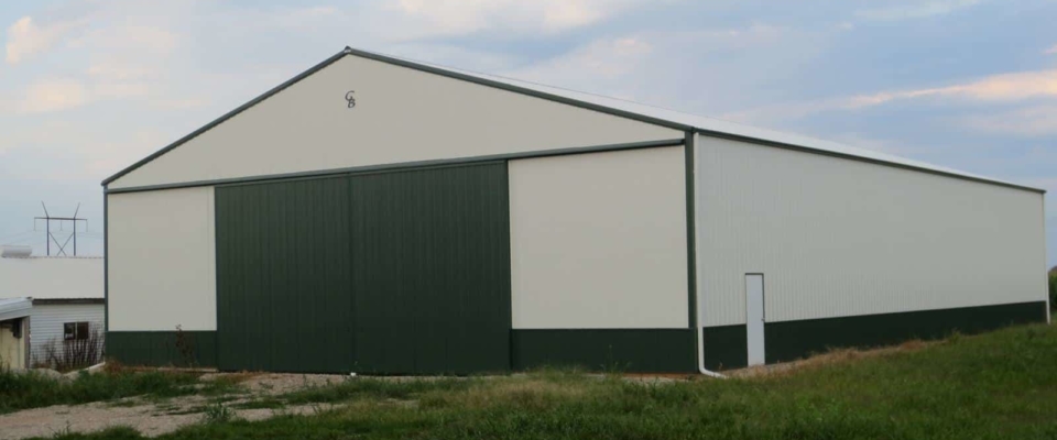 large green machine shed storage building on farm in iowa