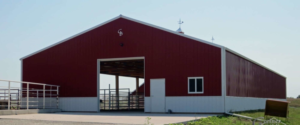 large red livestock post frame building in iowa