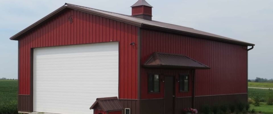 red and brown pole building garage white door