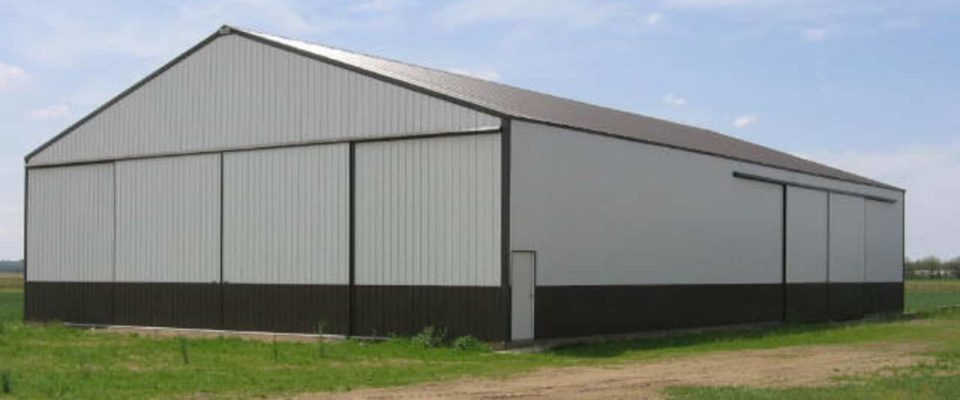 white and green machine shed with large sliding doors