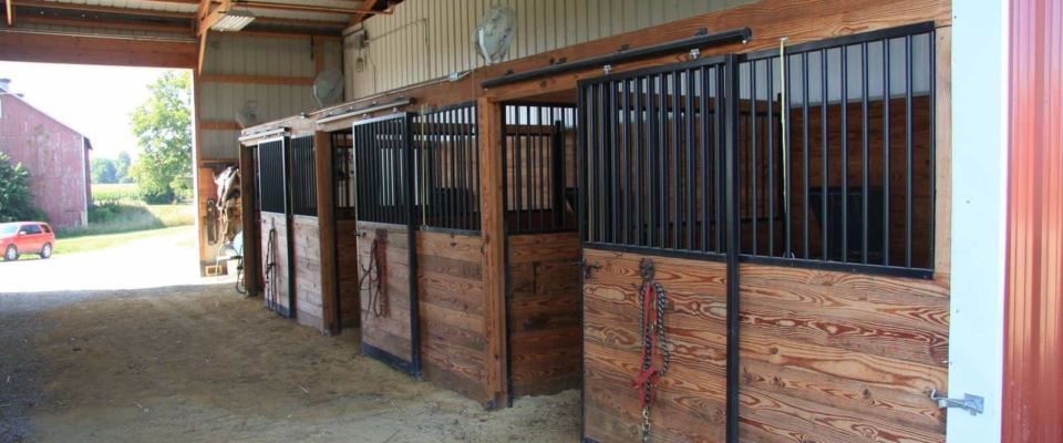 pole barn horse stable with outdoor riding arena