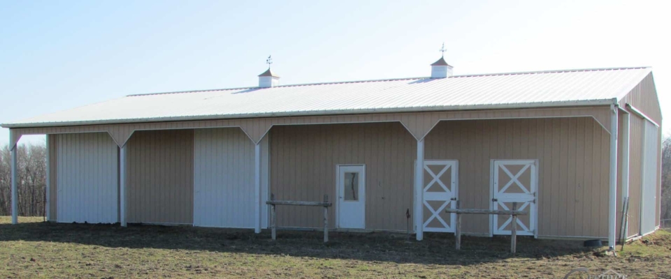 white and cream colored horse barn small post frame building