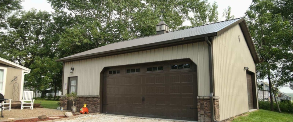 brown and tan post frame garage large door