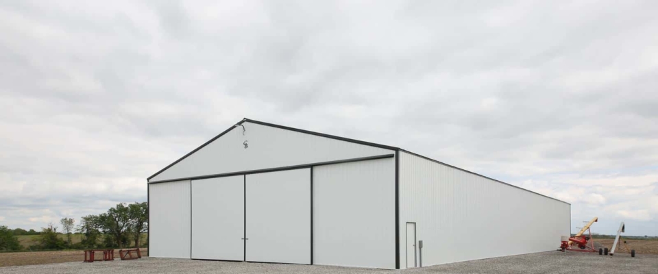 white machine shed building on farm