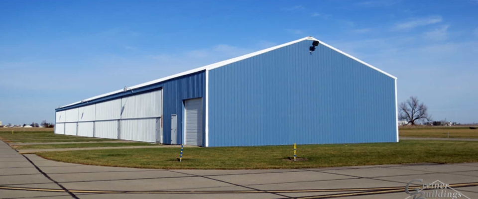 bright blue airplane hangar post frame building