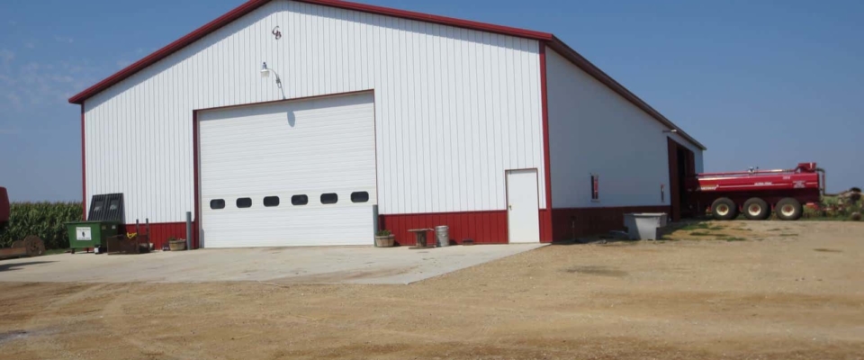 large white and red farm shed building for tractors and ag equipment