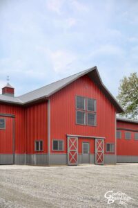Award Winning Post Frame Machine Shed Red with Smoke wainscot and roof in Prairie City