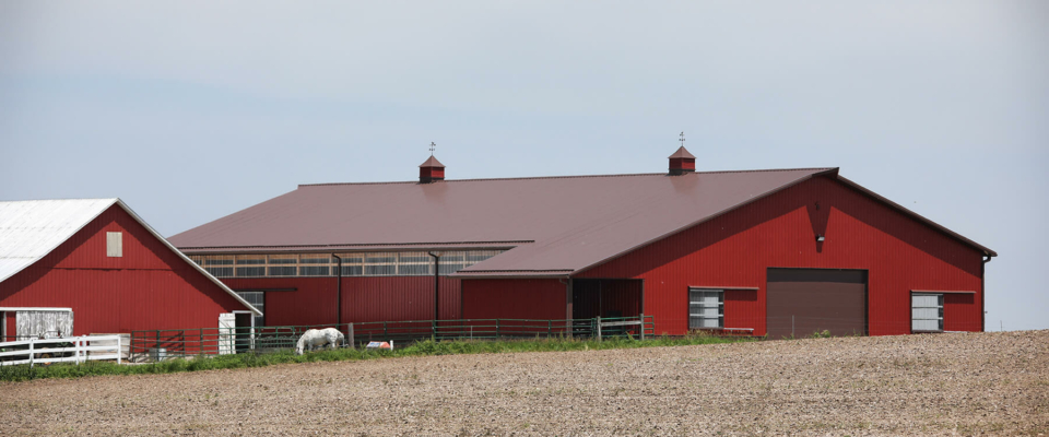 large post frame equestrian building red