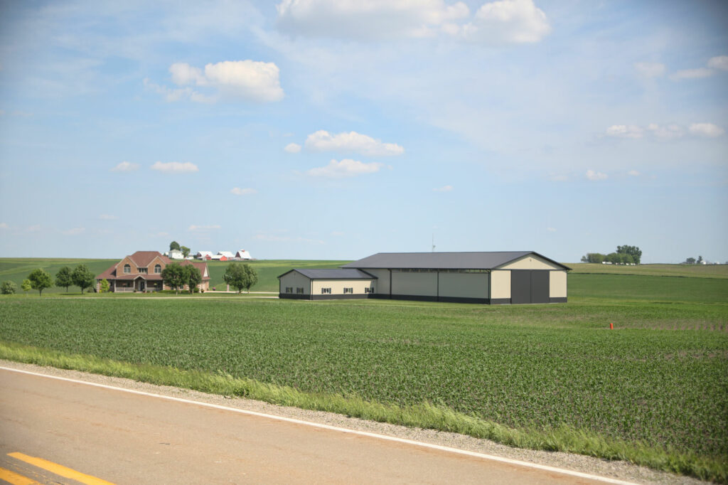 post frame farm building in field Greiner Buildings Rossiter-lined-insulated-shop-exterior-roadway