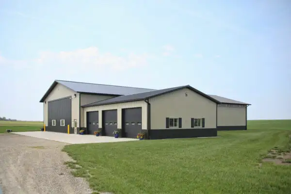 signature-series-large-tan-metal-building-complex-dark-trim-rural-field