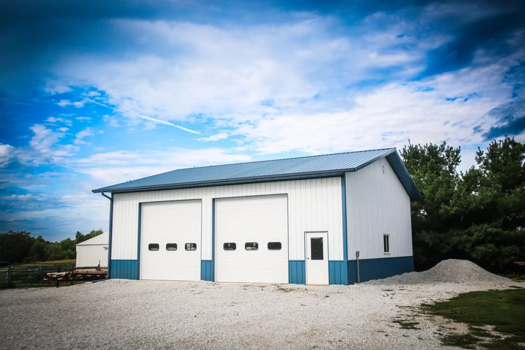 Front exterior of the Arctic Ocean LIS Garage with Arctic white siding, Ocean-colored roof, and dual closed garage doors.
